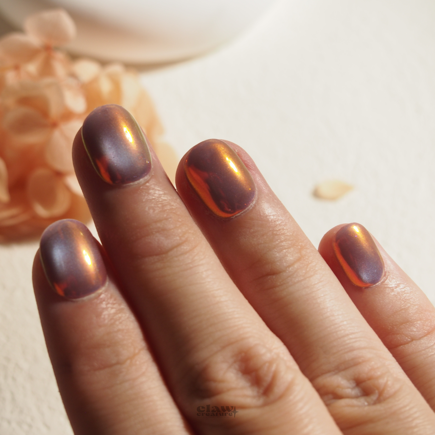 Iridescent Sunset Handmade Press-on Nails display on hand by Claw Creature