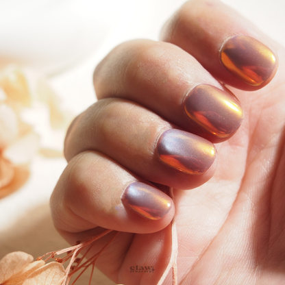 Iridescent Sunset Handmade Press-on Nails display on hand by Claw Creature