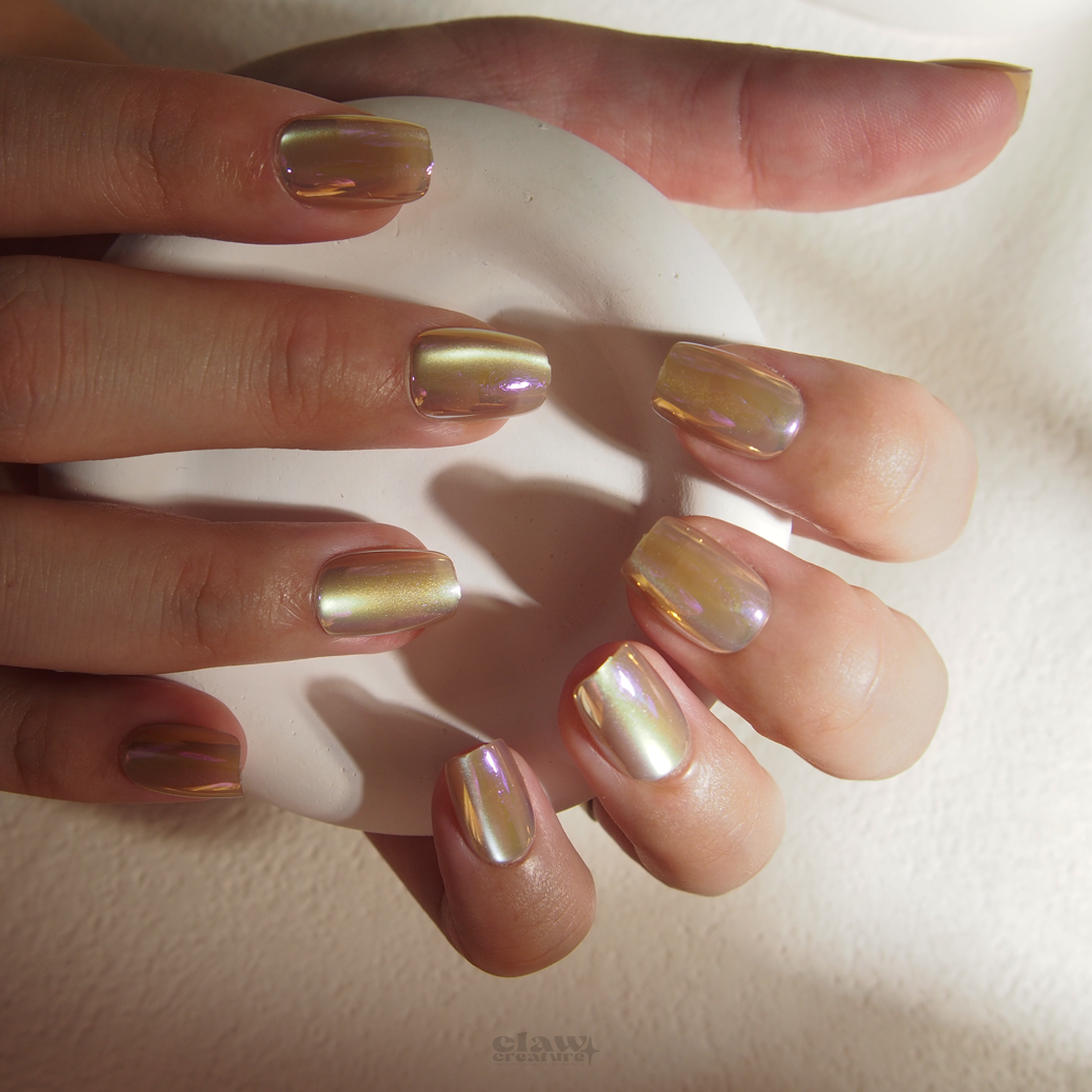 Champagne Iridescent Handmade Press-on Nails display on hand by Claw Creature