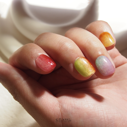 Rainbow Radiance Handmade Press-on Nails display on hand by Claw Creature