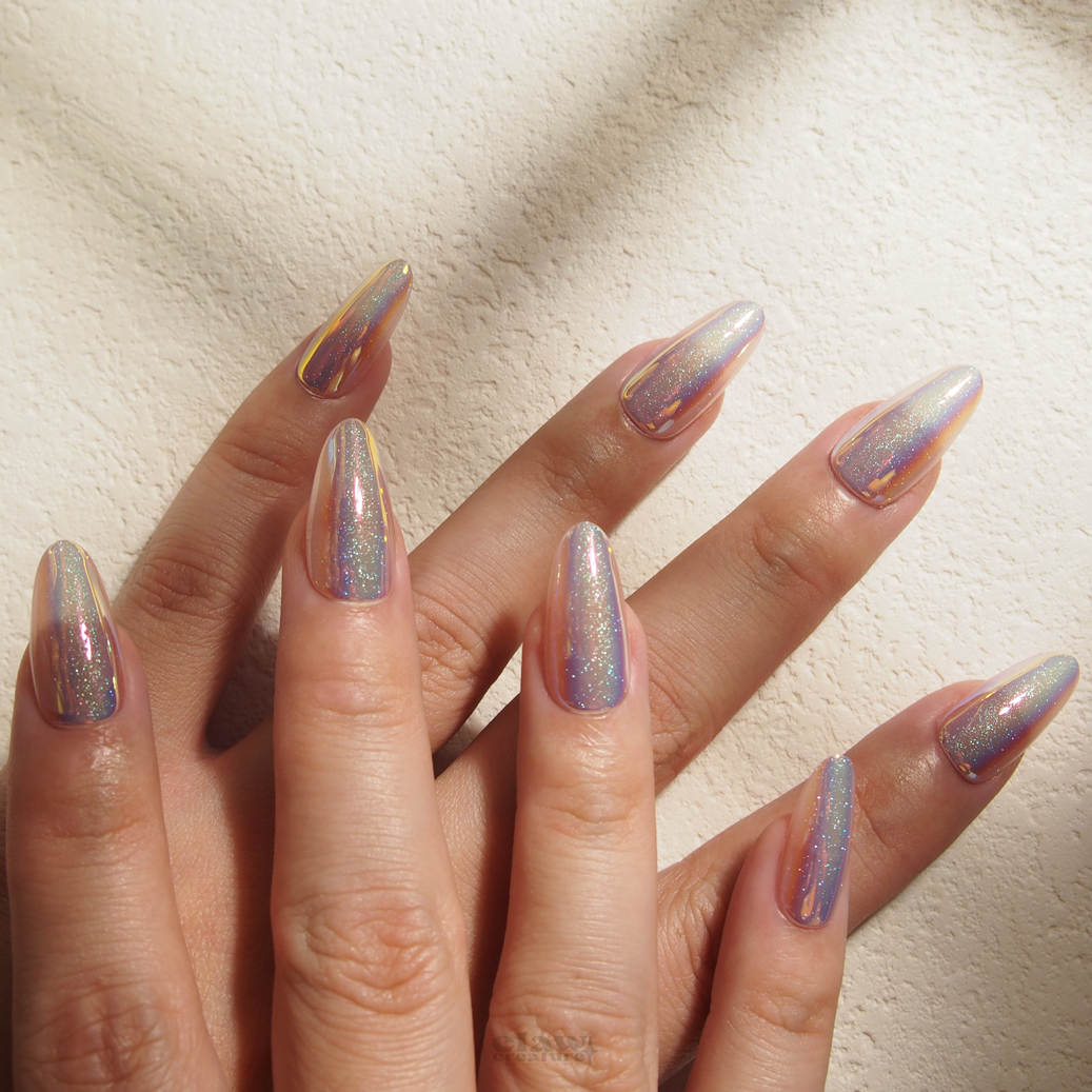 Iridescent Gleam Handmade Press-on Nails display on hand by Claw Creature